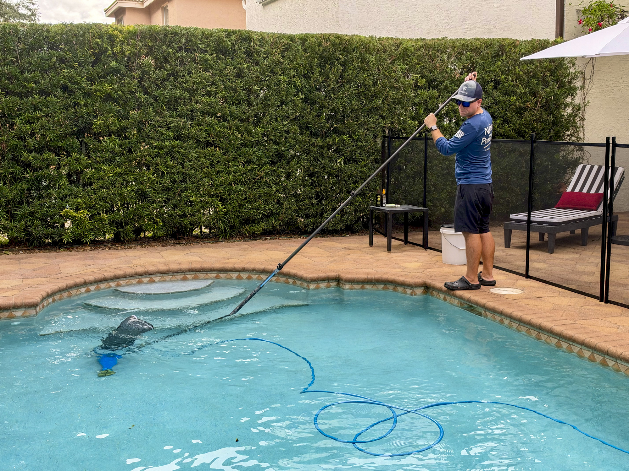 Northstar Pool & Spa technician performing a routine equipment check on a pool pump in West Boynton Beach