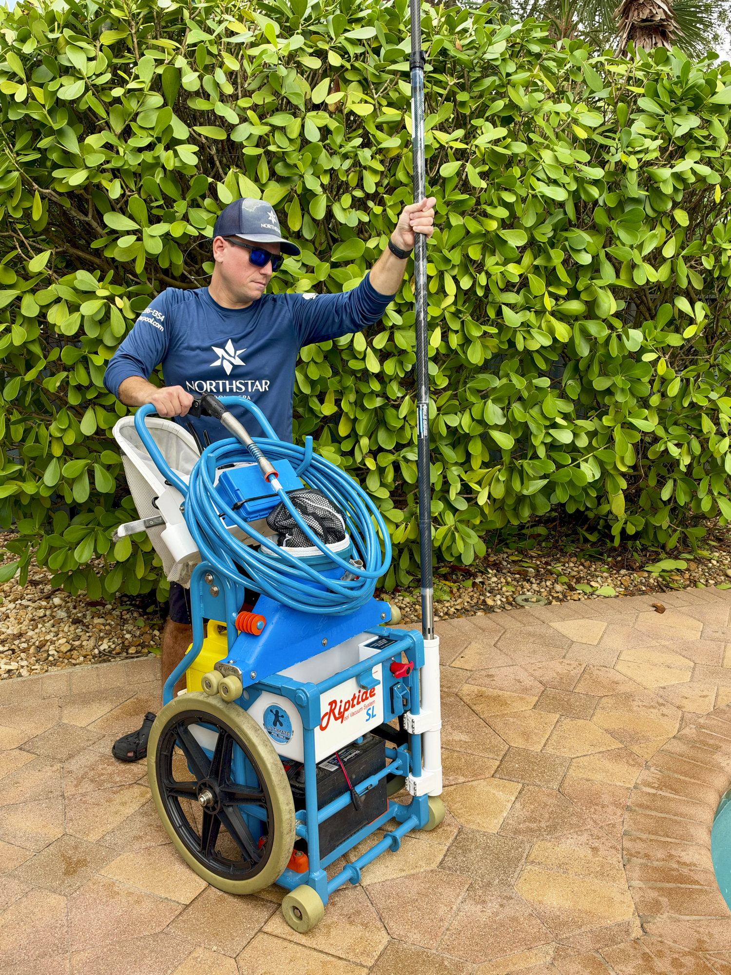 Northstar Pool & Spa technician with professional robotic pool cleaning equipment in West Boynton Beach