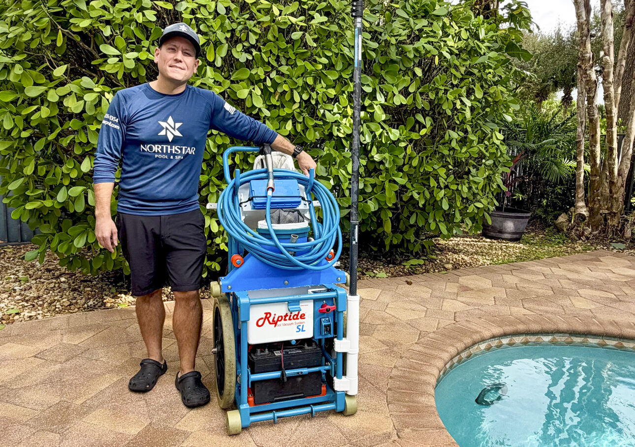 Northstar owner/technician performing pool service in a West Boynton Beach backyard